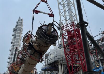 Industrial site with crane lifting very large and heavy part
